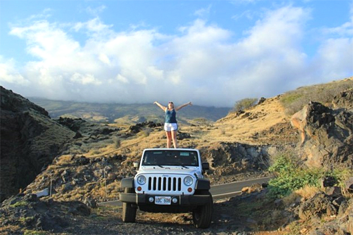 Person on top of a Maui Jeep rental